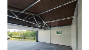 9×5.8m DELUX insulated mobile garage with gable roof, dark walnut walls, anthracite gray sectional door and door, 2 windows, 3 ventilation grilles, internal partition wall, internal door opening, trim, gutter, and anthracite gray tile-effect sheet roof covering